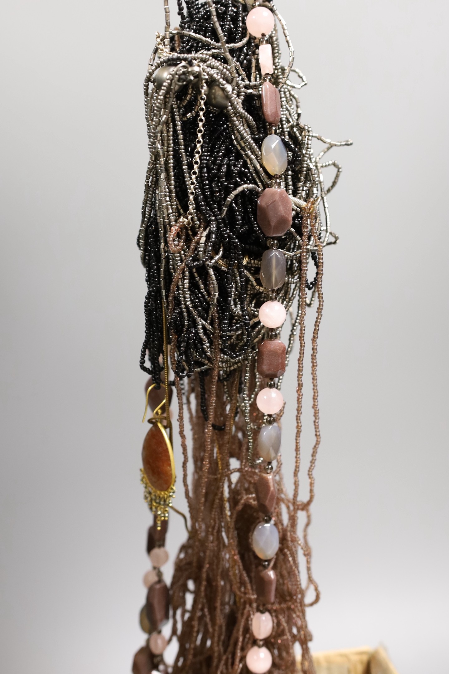 A quantity of assorted costume jewellery including necklaces and minor silver